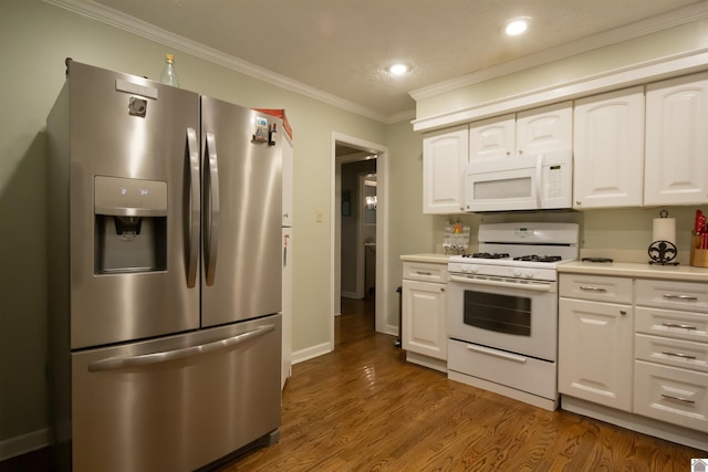 kitchen with white appliances, crown molding, white cabinets, and dark hardwood / wood-style floors