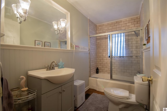 full bathroom with toilet, vanity, an inviting chandelier, and enclosed tub / shower combo