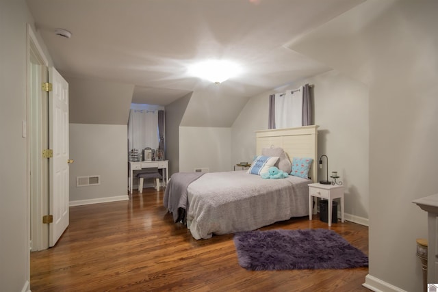 bedroom featuring dark wood-type flooring and lofted ceiling