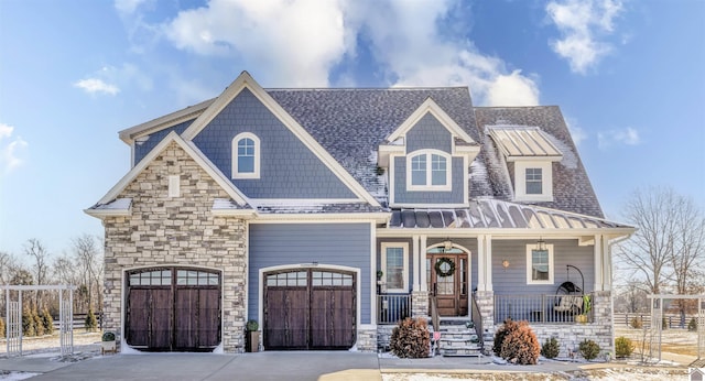 view of front of home featuring covered porch and a garage