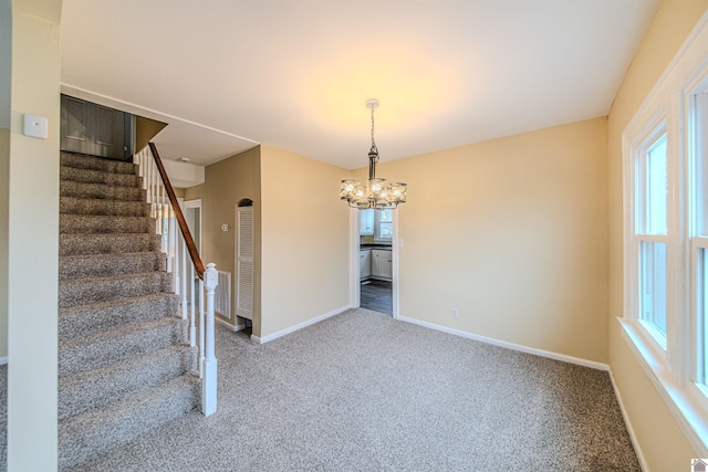 interior space with baseboards, a healthy amount of sunlight, and carpet flooring