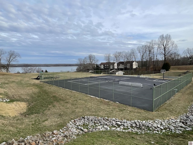 view of tennis court featuring fence