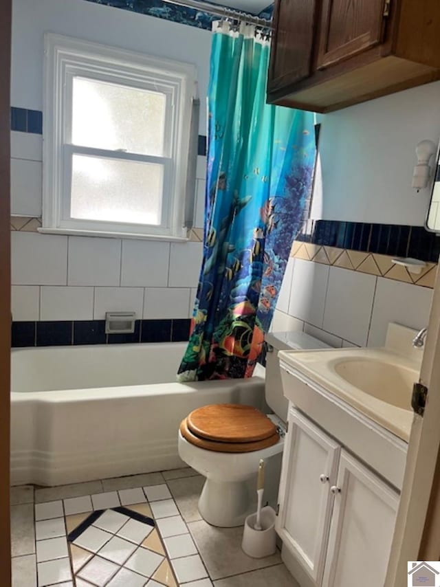 bathroom featuring toilet, shower / bathtub combination with curtain, vanity, and tile patterned floors