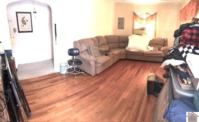 living area featuring electric panel and wood finished floors