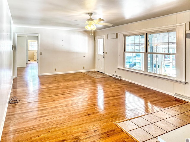 foyer entrance with light wood-type flooring, plenty of natural light, and baseboard heating