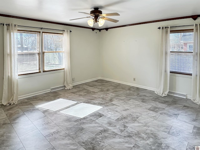 spare room featuring ceiling fan, visible vents, baseboards, and crown molding