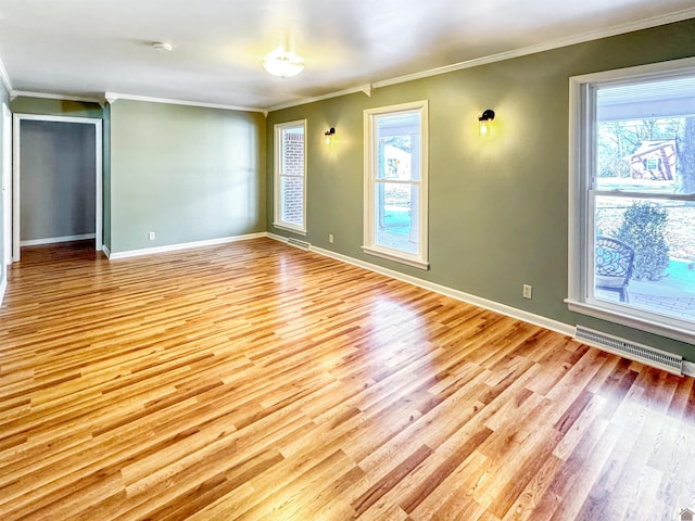 unfurnished room featuring baseboards, light wood-style flooring, visible vents, and a healthy amount of sunlight