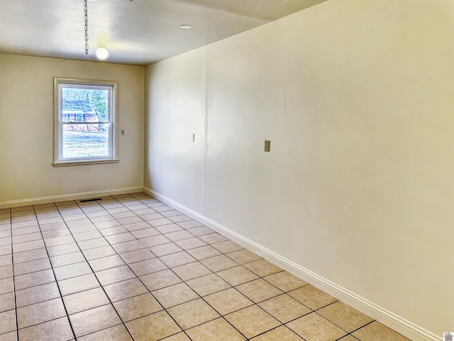 unfurnished room with visible vents and baseboards