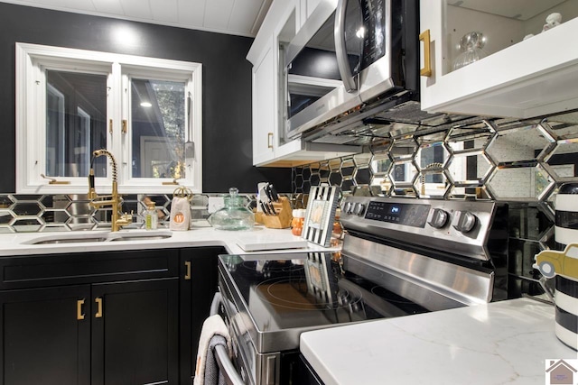 273 Bayshore Dr, Cadiz, KY 42211 - kitchen with appliances with stainless steel finishes, dark cabinets, backsplash, white cabinetry, and glass insert cabinets