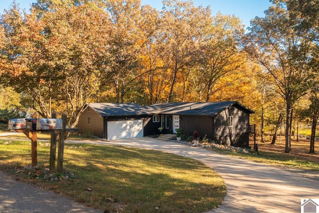 273 Bayshore Dr, Cadiz, KY 42211 - view of front of home featuring concrete driveway, a garage, and a front lawn