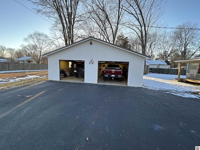 detached garage featuring fence