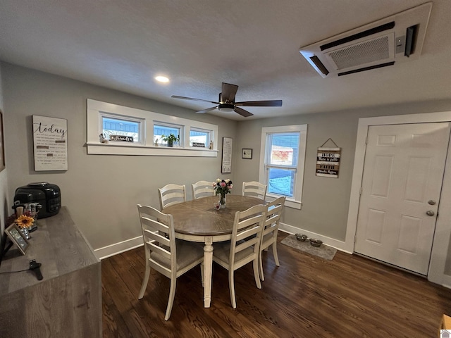 dining room with dark wood-type flooring, baseboards, and a ceiling fan