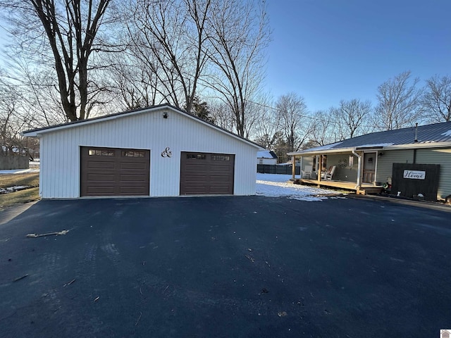 detached garage featuring covered porch