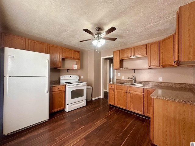 kitchen featuring ceiling fan, white appliances, dark wood-style flooring, a sink, and light countertops