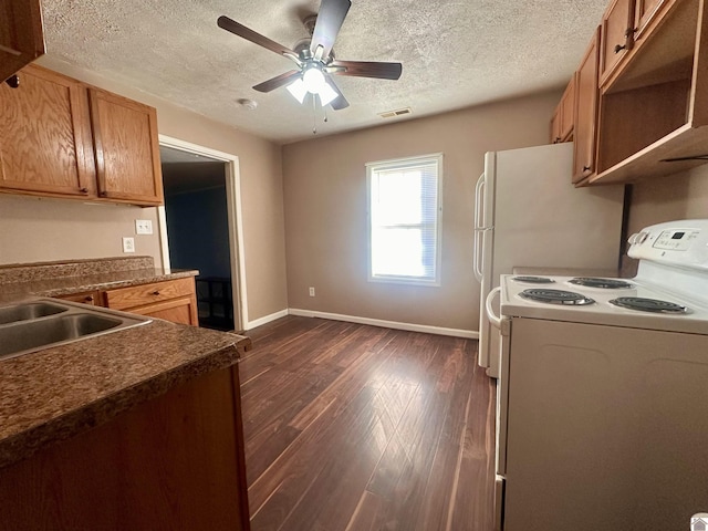 kitchen featuring dark wood-style floors, dark countertops, brown cabinets, and electric range