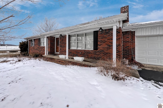 ranch-style house featuring brick siding and an attached garage