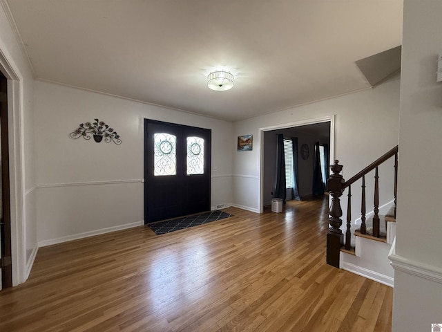 foyer featuring stairs, french doors, wood finished floors, and baseboards