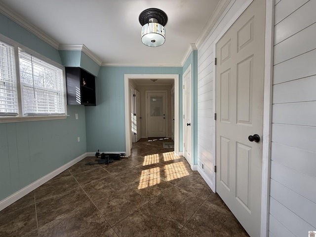 interior space with crown molding and baseboards