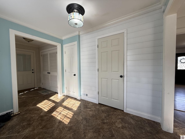 unfurnished bedroom featuring baseboards and ornamental molding