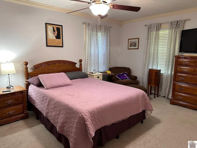 bedroom featuring a ceiling fan, crown molding, and light colored carpet