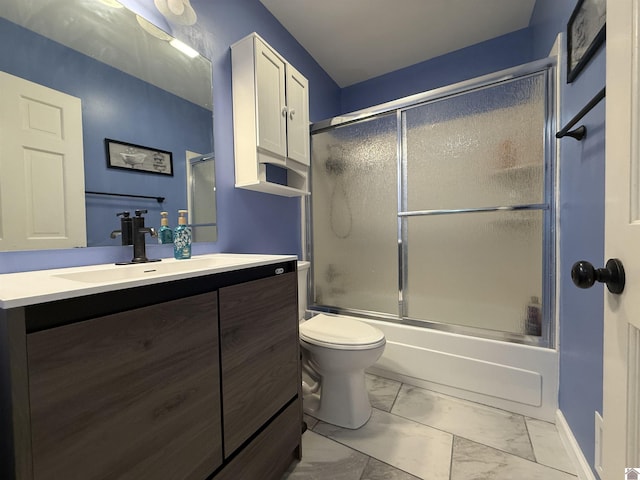 full bathroom with enclosed tub / shower combo, toilet, vanity, baseboards, and marble finish floor