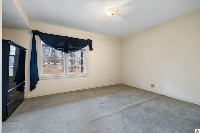 spare room with carpet flooring and baseboards