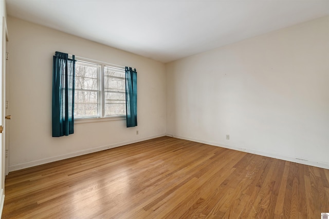 unfurnished room featuring light wood-style flooring and baseboards