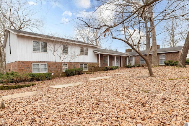 split level home with brick siding and a chimney