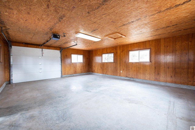 garage featuring wooden walls and a garage door opener