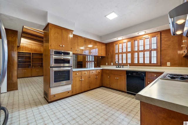 kitchen featuring brown cabinetry, appliances with stainless steel finishes, and light countertops