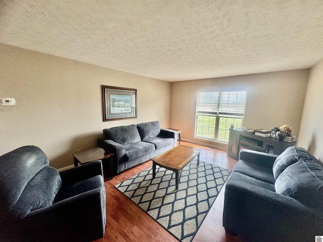 living area featuring a textured ceiling and wood finished floors