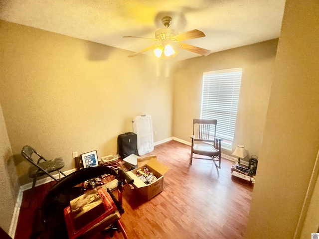 misc room with ceiling fan, baseboards, and wood finished floors