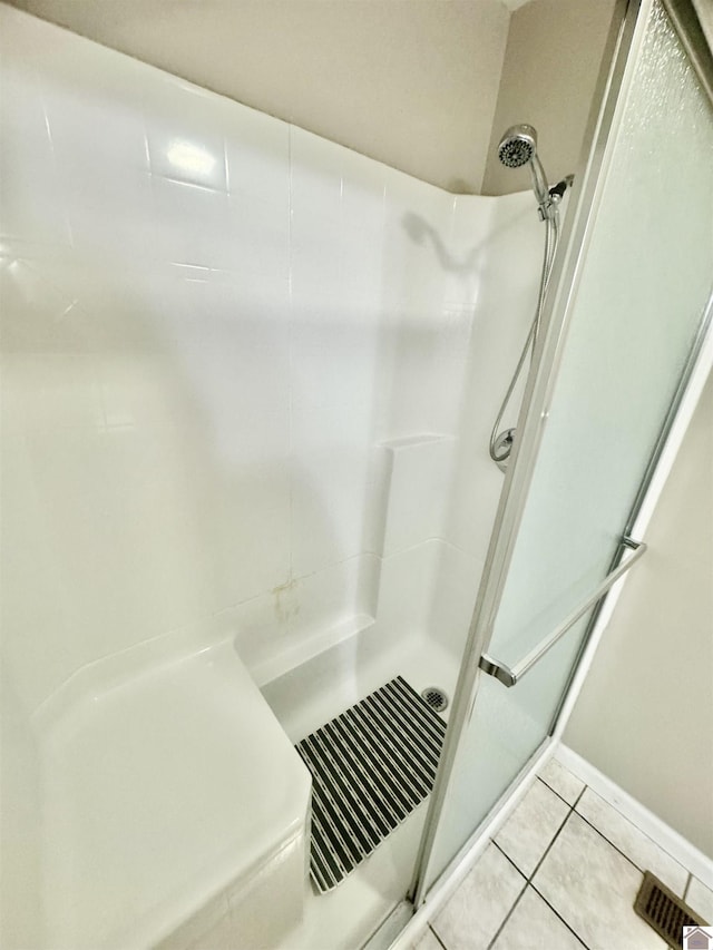 full bathroom with a shower stall and tile patterned floors