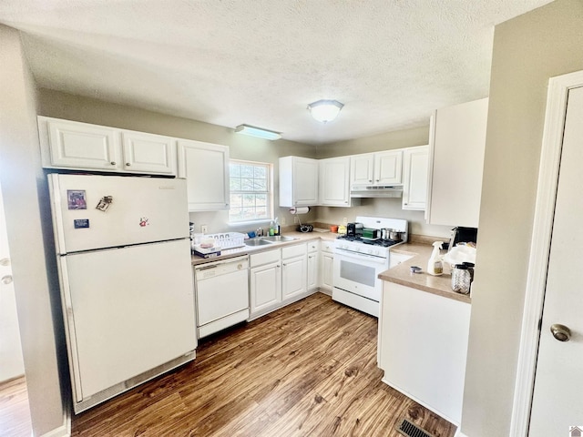 kitchen with light wood-style floors, white cabinets, a sink, white appliances, and under cabinet range hood