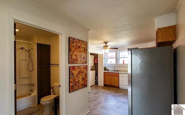 interior space featuring brown cabinets, freestanding refrigerator, white dishwasher, light countertops, and a sink