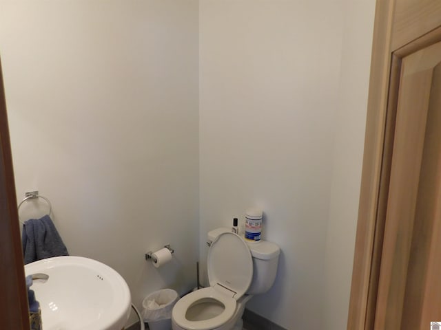 bathroom featuring toilet and a sink