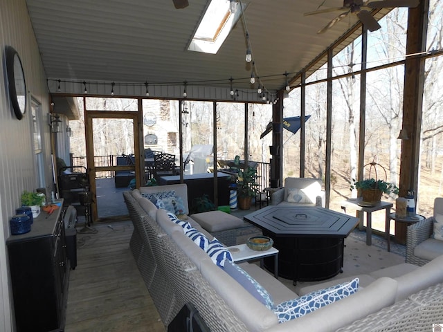 sunroom featuring a skylight and a ceiling fan