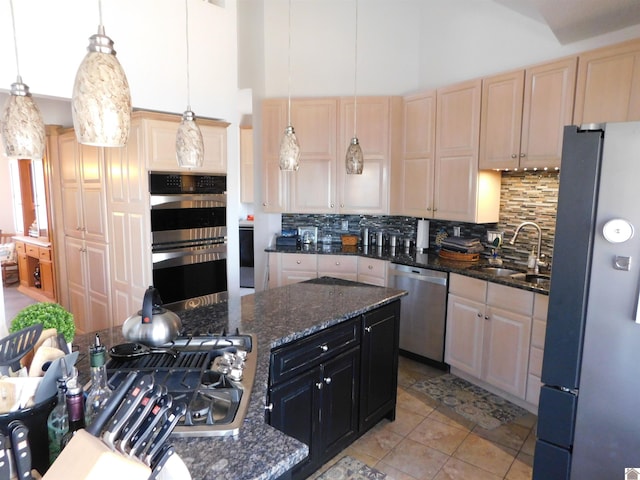 kitchen with appliances with stainless steel finishes, dark stone countertops, dark cabinets, decorative light fixtures, and light brown cabinets