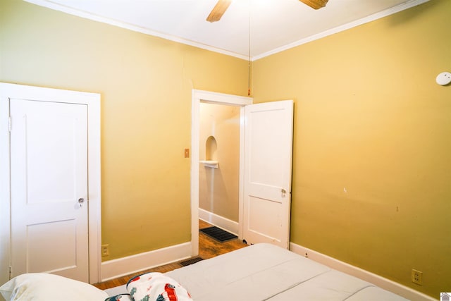 bedroom with wood finished floors, a ceiling fan, baseboards, visible vents, and crown molding