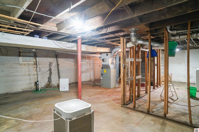 unfinished basement featuring heating unit