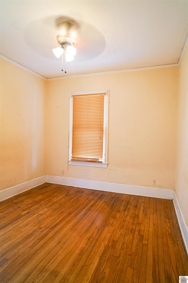 unfurnished room with a ceiling fan, baseboards, crown molding, and wood finished floors