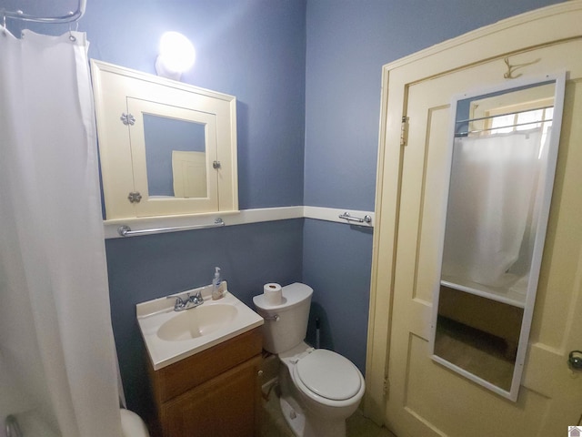 full bathroom with toilet and vanity