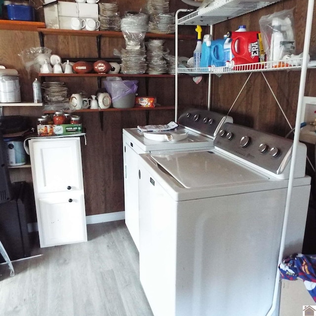 washroom featuring laundry area, light wood-style flooring, and washer and dryer