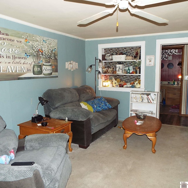 carpeted living area with ceiling fan and ornamental molding