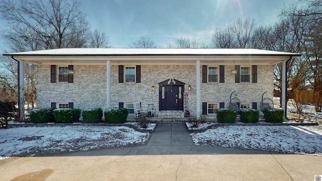 split foyer home featuring brick siding