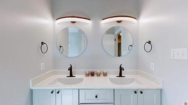 bathroom featuring a sink and double vanity