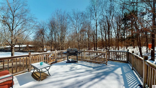 snow covered deck featuring a grill