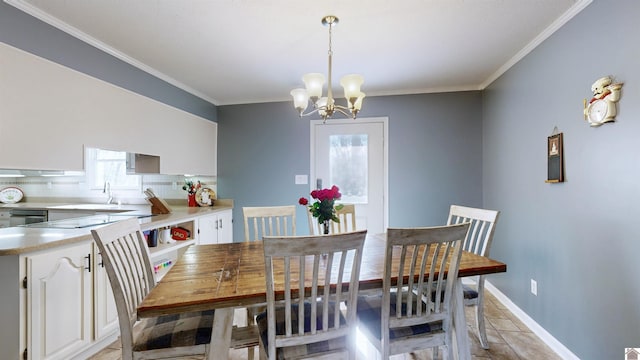 dining space with baseboards, an inviting chandelier, and crown molding