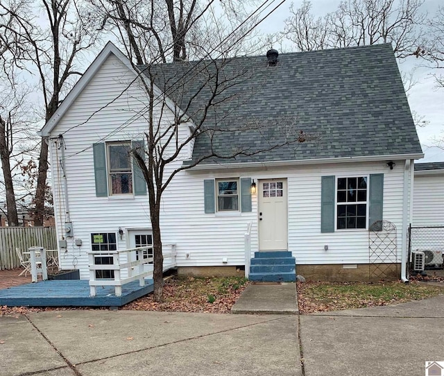 view of front facade with entry steps, crawl space, fence, and roof with shingles