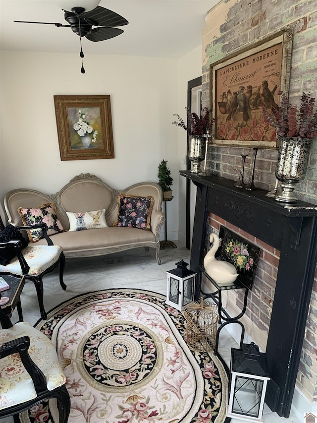 sitting room featuring a ceiling fan, a brick fireplace, and brick wall